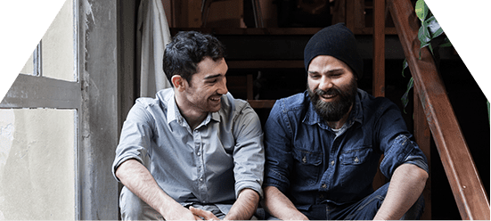two men on sitting on stairs discussing addiction