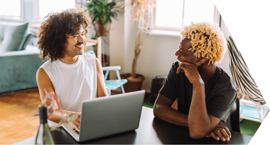 two men on laptop discussing insurance
