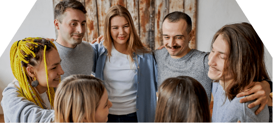 group of people in circle with arms around each other in intensive outpatient program