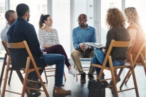 members of the lgbtq community attend a group therapy session as part of their substance use disorder treatment 
